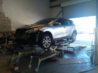Wrecked SUV being evaluated for collision repair